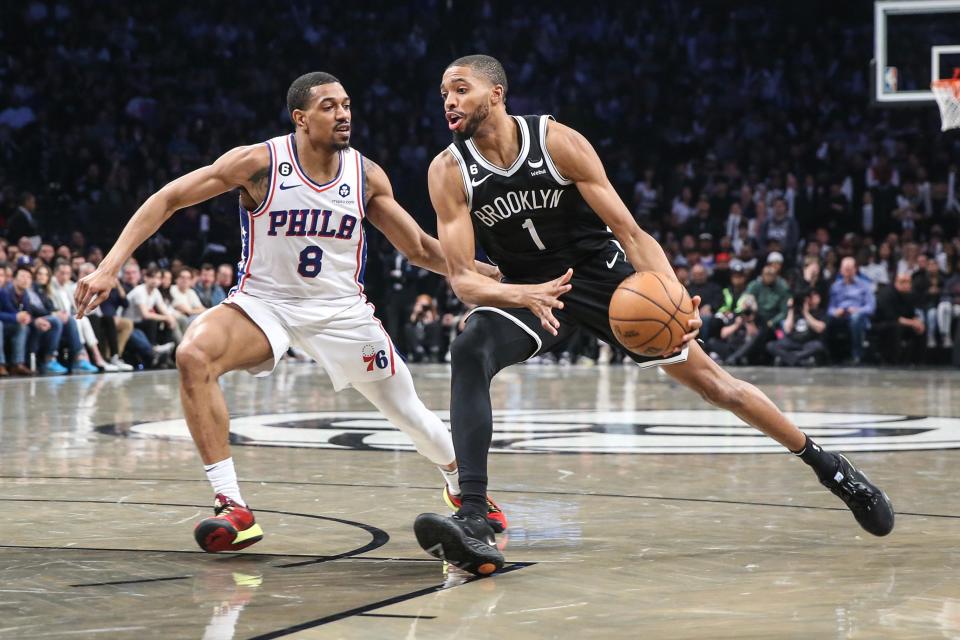 Brooklyn Nets forward Mikal Bridges looks to drive past Philadelphia 76ers guard De'Anthony Melton during Game 3 of the first round in the NBA playoffs at Barclays Center in Brooklyn, N.Y., April 20, 2023.