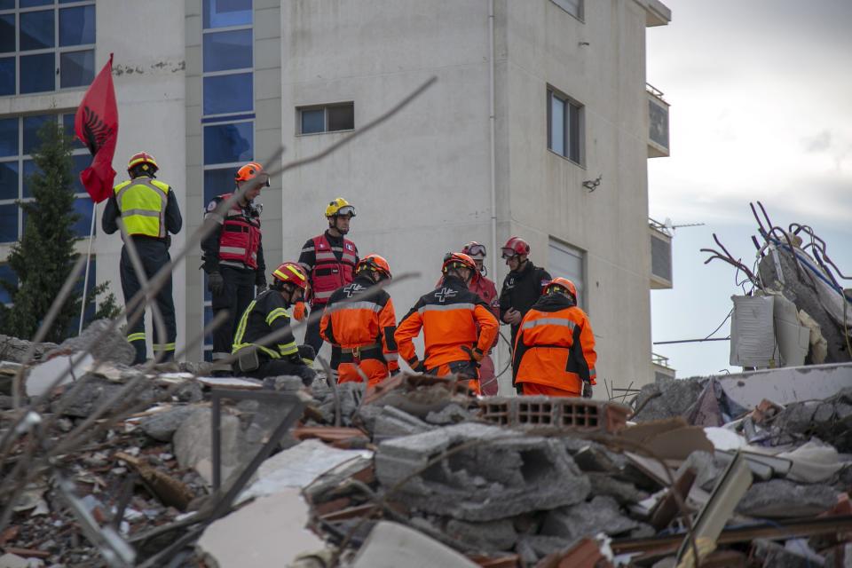 In this photo taken on Friday, Nov. 29, 2019, rescuers from France and Switzerland operate at a collapsed building after the 6.4-magnitude earthquake in Durres, western Albania. In the initial hours after a deadly pre-dawn earthquake struck Albania, pancaking buildings and trapping dozens of sleeping people beneath the rubble, the country’s neighbors sprang into action. Offers of help flooded in from across Europe and beyond, with even traditional foes setting aside their differences in the face of the natural disaster. The 6.4-magnitude earthquake that struck Albania on Tuesday killed at least 49 people, injured 2,000 and left at least 4,000 homeless (AP Photo/Visar Kryeziu)