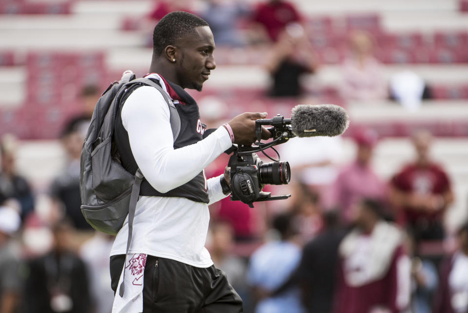 South Carolina wide receiver Deebo Samuel films his teammates during warm-ups before the start of an NCAA college football game Saturday, Oct. 28, 2017, in Columbia, S.C. South Carolina defeated Vanderbilt 34-27. (AP Photo/Sean Rayford)