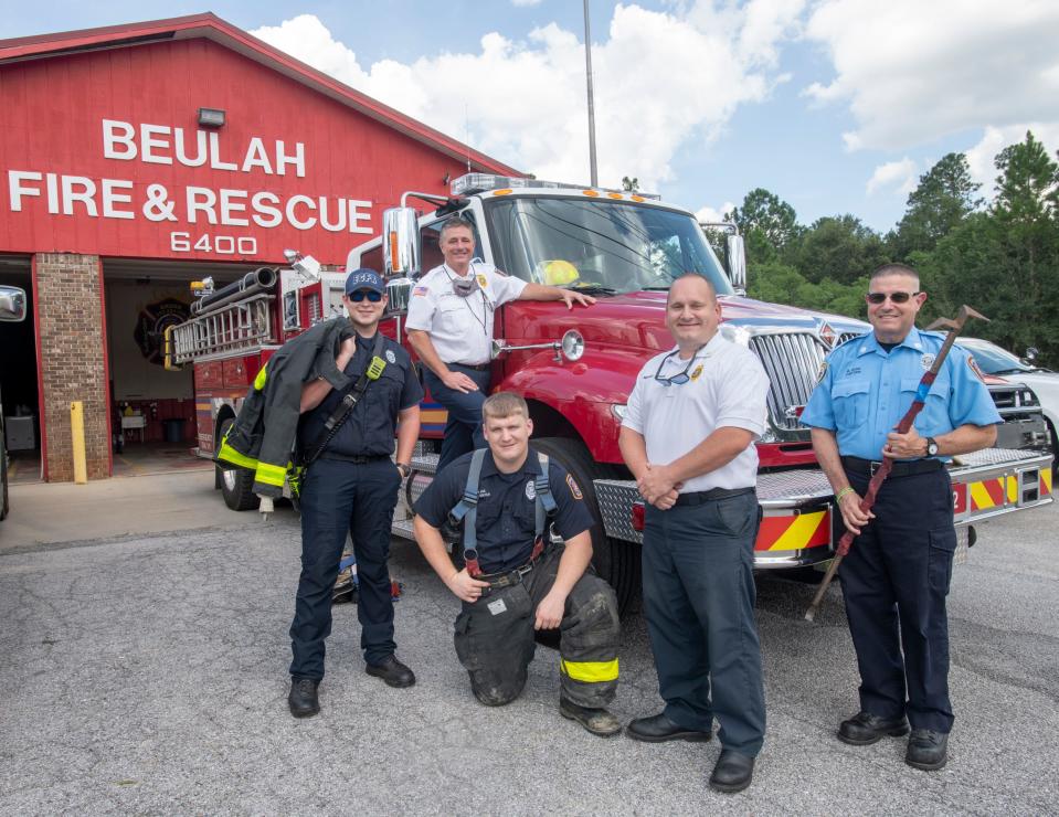 From left, firefighter Nathan Klingsman, District Chief Chris Hatch, firefighter Reed Moss, Assistant Chief Michael Aaron, and Capt. Matt Russ stand outside the Beulah Fire & Rescue station on West Nine Mile Road on Friday, Sept. 3, 2021.