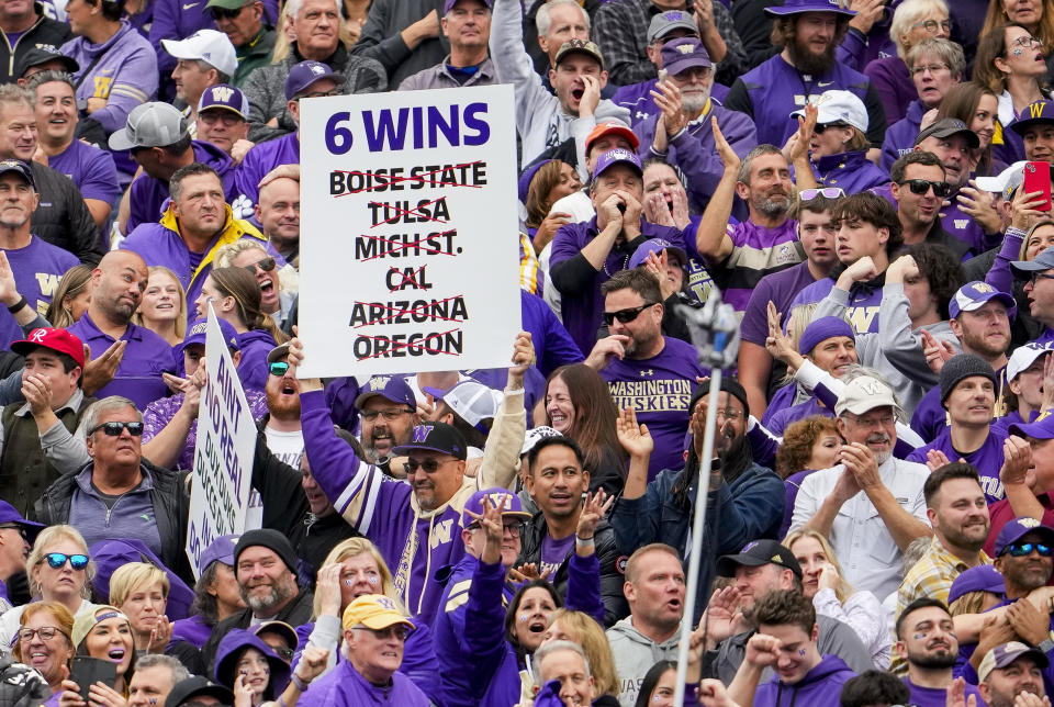 A fan holds a sign listing Washington's previous wins during the season during the second half of an NCAA college football game against Oregon, Saturday, Oct. 14, 2023, in Seattle. Washington won 36-33. (AP Photo/Lindsey Wasson)