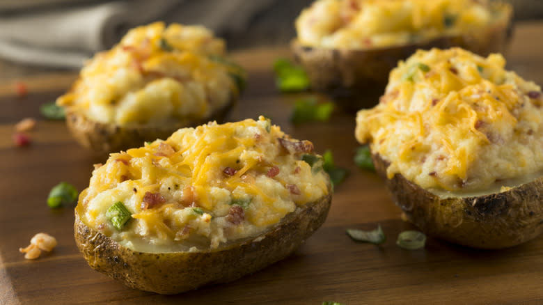 Twice-baked potatoes on cutting board 