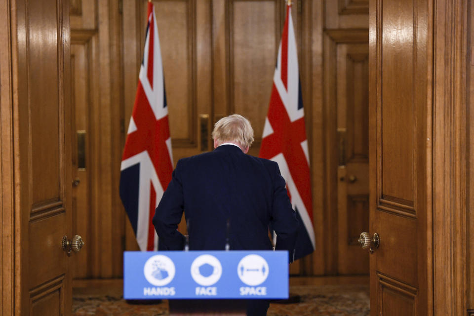 Britain's Prime Minister Boris Johnson leaves following a coronavirus briefing in Downing Street, London, Monday, Oct. 12, 2020. (Toby Melville/Pool Photo via AP)