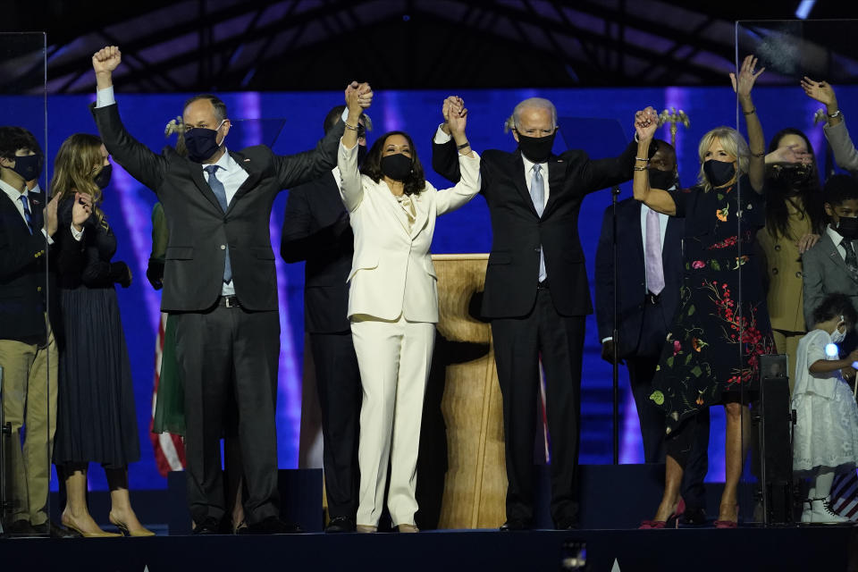 From left, Doug Emhoff, husband of Vice President-elect Kamala Harris, Harris, President-elect Joe Biden and his wife Jill Biden on stage together, Saturday, Nov. 7, 2020, in Wilmington, Del. (Andrew Harnik/Pool via AP)