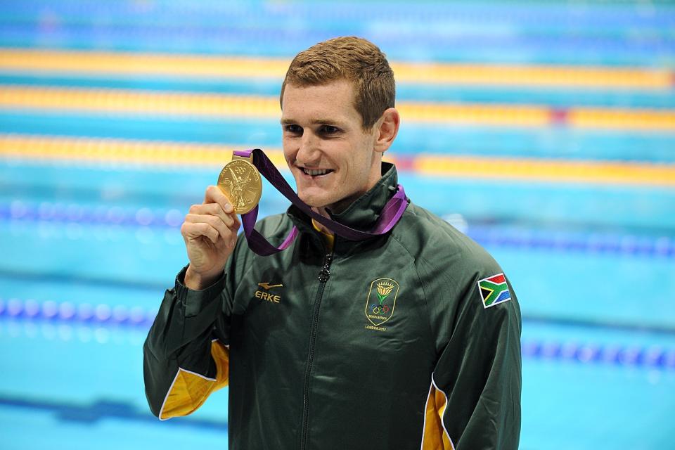 South Africa's Cameron van der Burgh shows off his gold medal after winning the 100 meter breaststroke final. (Photo: Tony Marshall - PA Images via Getty Images)