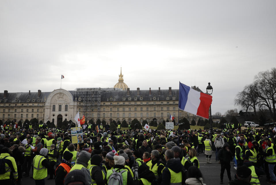 Yellow vest demonstrators gather at the Invalides monument before a march in Paris, Saturday, Jan.19, 2019. Yellow vest protesters are planning rallies in several French cities despite a national debate launched this week by President Emmanuel Macron aimed at assuaging their anger. (AP Photo/Kamil Zihnioglu)