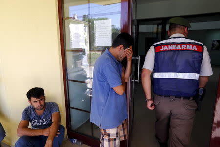 Abdullah Kurdi (2nd R), father of three-year-old Aylan Kurdi, waits in front of a morgue in Mugla, Turkey, September 3, 2015. REUTERS/Murad Sezer