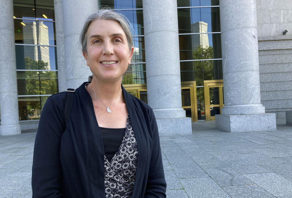 FILE - Colorado lawyer Autumn Scardina poses for photos outside the Ralph Carr Colorado Judicial Center in Denver, Oct. 5, 2022. The Colorado Supreme Court will hear arguments Tuesday, June 18, 2024, in a lawsuit against Jack Phillips, the Christian baker who refused to make a cake celebrating a gender transition. Phillips was sued by Scardina, a transgender woman, after Phillips and his suburban Denver bakery refused to make a pink cake with blue frosting for her birthday and to celebrate her gender transition. (AP Photo/Colleen Slevin, File)