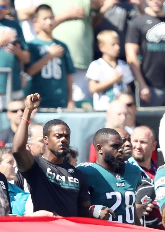 Philadelphia Eagles players lock arms during the national anthem before the game against the New York Giants