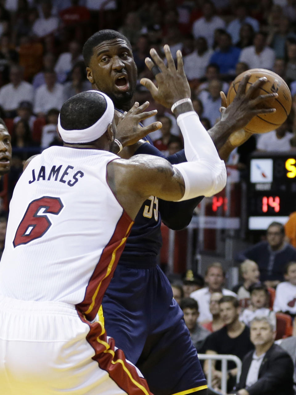 Indiana Pacers' Roy Hibbert (55) drives to the basket as Miami Heat's LeBron James (6) defends during the first half of an NBA basketball game, Friday, April 11, 2014, in Miami. (AP Photo/Lynne Sladky)