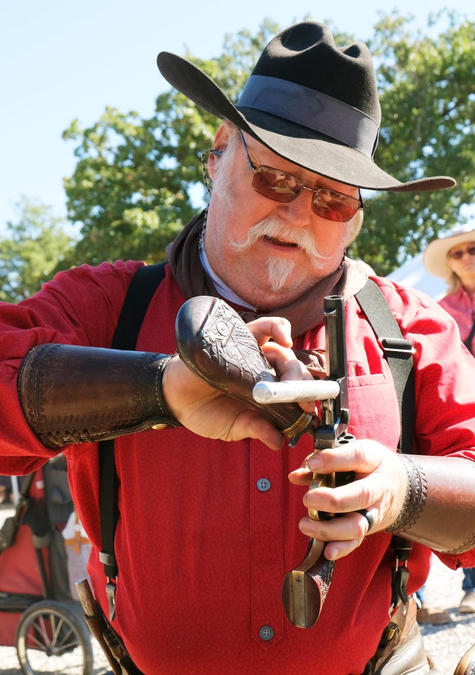 Jimmy Dokey, "Yosemite Jim," of Hawley, Texas, reloads his black powder pistol before a competition on Friday, Oct. 14, 2022, at the Oklahoma City Gun Club. The cowboy action shooting national championship was held at the gun club this year.