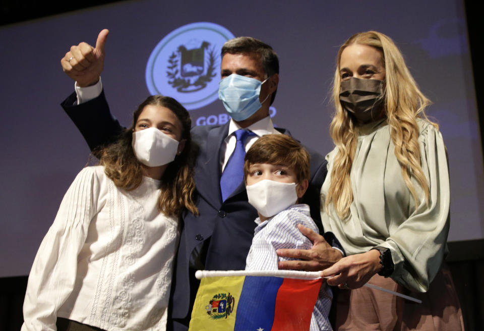 Venezuelan opposition leader Leopoldo Lopez with his wife Lilian Tintori and their son and daughter pose for a photo after a news conference in Madrid on Tuesday, Oct. 27, 2020. Prominent opposition activist Leopoldo López who has abandoned the Spanish ambassador's residence in Caracas and left Venezuela after years of frustrated efforts to oust the nation's socialist president is holding a news conference in Madrid. (AP Photo/Andrea Comas)