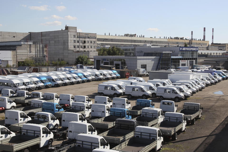FILE - New vehicles Gazelle are parked in the territory of the Gorky Automobile plant (GAZ), one of the main budget-forming enterprises in the region in Nizhny Novgorod, Russia, on Aug. 11, 2022. After a year of far-reaching sanctions aimed at degrading Moscow's war chest, economic life for ordinary Russians doesn't look all that different than it did before the invasion of Ukraine. But with restrictions finally tightening on the Kremlin's chief moneymaker — oil — the months ahead will be an even tougher test of President Vladimir Putin's fortress economy. (AP Photo, File)