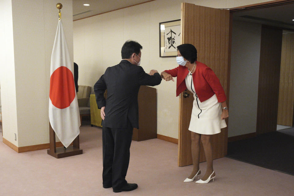 United Nations Secretary General's Special Envoy to Myanmar Christine Schraner Burgener, right, and Japan's Foreign Minister Toshimitsu Motegi, left, greet prior to a courtesy call at the Ministry of Foreign Affairs Friday, May 28, 2021, in Tokyo. (AP Photo/Eugene Hoshiko, Pool)