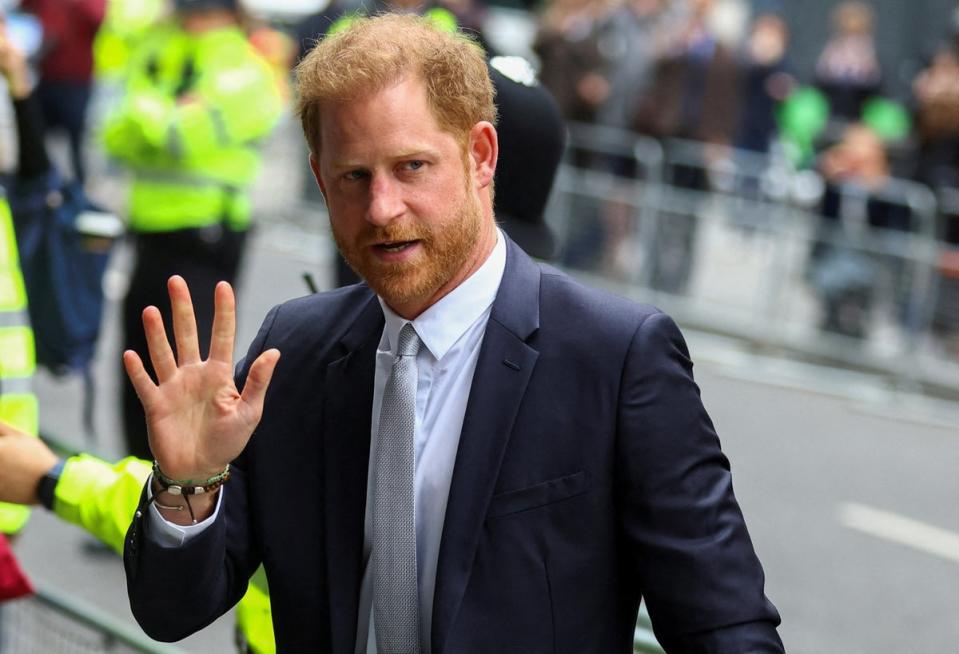 Prince Harry walks outside the Rolls Building of the High Court in London in June (Reuters)