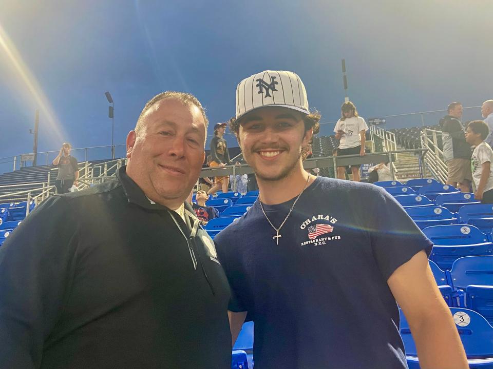 Spackenkill pitcher Andrew Speranza, right, poses with his father, David Speranza, as the two watch the Roy C. Ketcham baseball team compete in a regional semifinal at Dutchess Stadium on June 2, 2022.