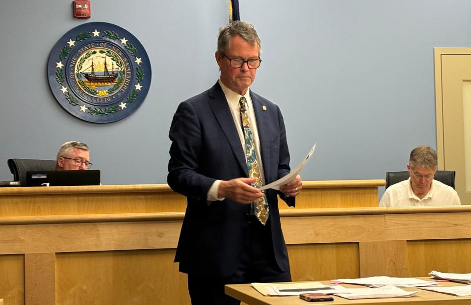 Paul Sorli, right, co-owner of the Portsmouth Gas Light Co., testifies at a New Hampshire Liquor Commission hearing in Concord on Wednesday, Nov. 15, 2023. His business' attorney, Jon Flagg, is seen standing, while the hearing's presiding officer, Stephen Judge, is seated to the left.