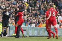 Liverpool's Raheem Sterling (C) celebrates his goal against Norwich City with manager Brendan Rodgers (2nd L) during their English Premier League soccer match at Carrow Road in Norwich April 20, 2014. REUTERS/Stefan Wermuth