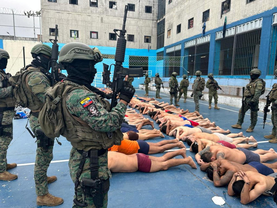 Ecuadorian soldiers stand guard over inmates in the courtyard after taking control of the Ceunca prison, in Cuenca, Ecuador, in a handout picture made available on Jan. 14, 2024. / Credit: Armed Forces of Ecuador/Handout/REUTERS
