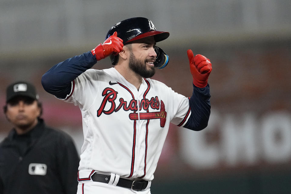 Atlanta Braves' Travis d'Arnaud gestures to the dugout after reaching second base on a double in the fourth inning of a baseball game against the Philadelphia Phillies Tuesday, Sept. 19, 2023. (AP Photo/John Bazemore)