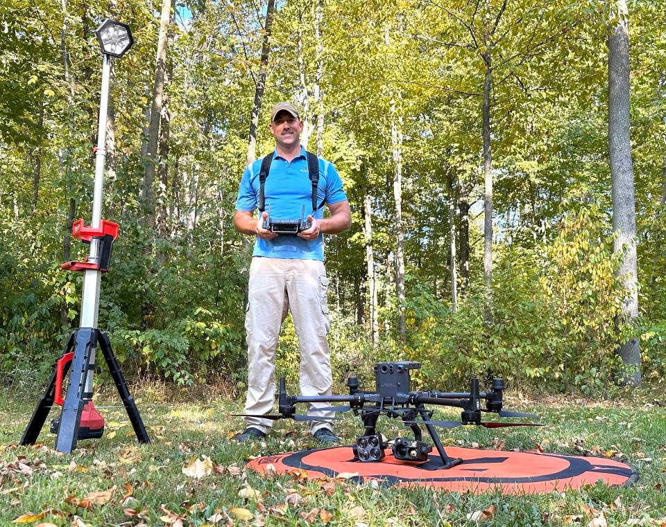 Nick Wayerski of Marshfield Drones displays a drone fitted with a thermal camera for game recovery as well as a light stand and landing pad used in nighttime flights.