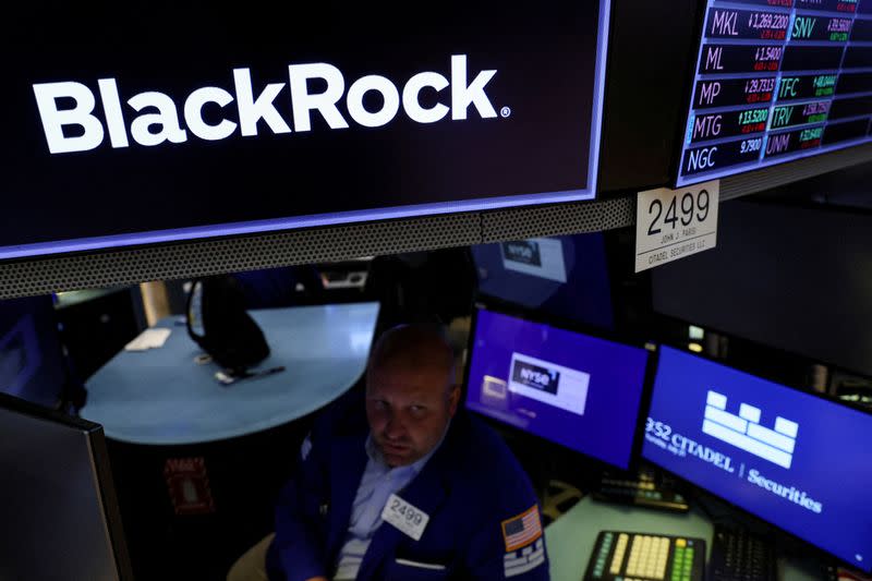 FILE PHOTO: Traders work on the floor of the NYSE in New York