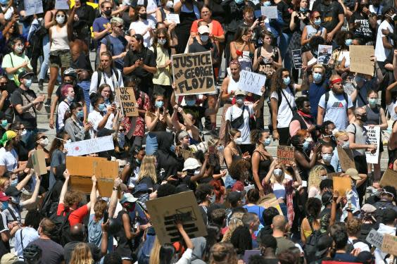 Some in the London crowd wore masks (PA)