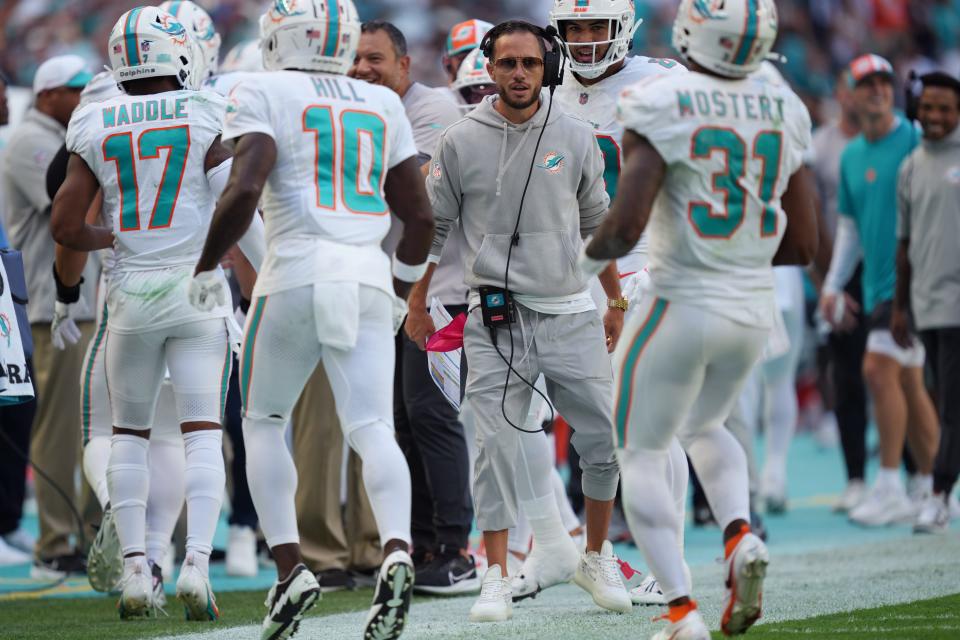 Miami Dolphins head coach Mike McDaniel congratulates his team after running back Raheem Mostert broke a big run during the first half of an NFL game against the Carolina Panthers at Hard Rock Stadium in Miami Gardens, Oct. 15, 2023.