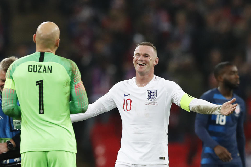 England's Wayne Rooney, right, jokes with Unites States goalkeeper Brad Guzan who stopped Rooney's shot on goal during the international friendly soccer match between England and the United States at Wembley stadium, Thursday, Nov. 15, 2018. (AP Photo/Alastair Grant)