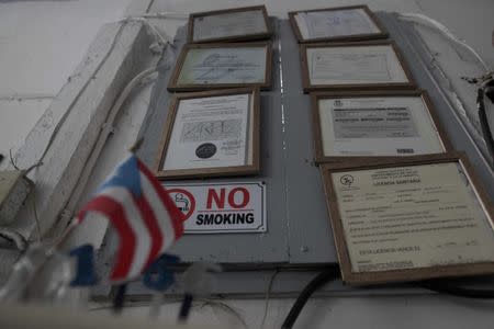 Government-issued licences and permits are seen at a bar in San Juan, Puerto Rico, November 4, 2016. REUTERS/Alvin Baez