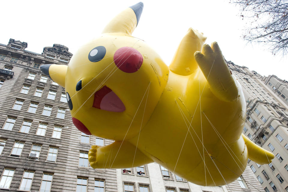 FILE - This Nov. 26, 2009 file photo shows the Pikachu Pokemon balloon floating down Central Park West during the Macy's Thanksgiving Day Parade in New York. The parade has to be a crowd-pleaser for a multigenerational crowd. More than 3 million people typically attend the event that also unfolds in front of a TV audience of 50 million. This year's parade will feature balloons include Papa Smurf and the Elf on a Shelf, while Buzz Lightyear, Sailor Mickey Mouse and the Pillsbury Doughboy keep their place in the lineup. A new version of Hello Kitty is also to be included. (AP Photo/Charles Sykes, file)