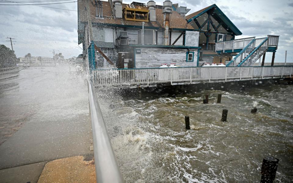 Waves crash against a building ahead of the arrival of Hurricane Helene in Cedar Key, Florida