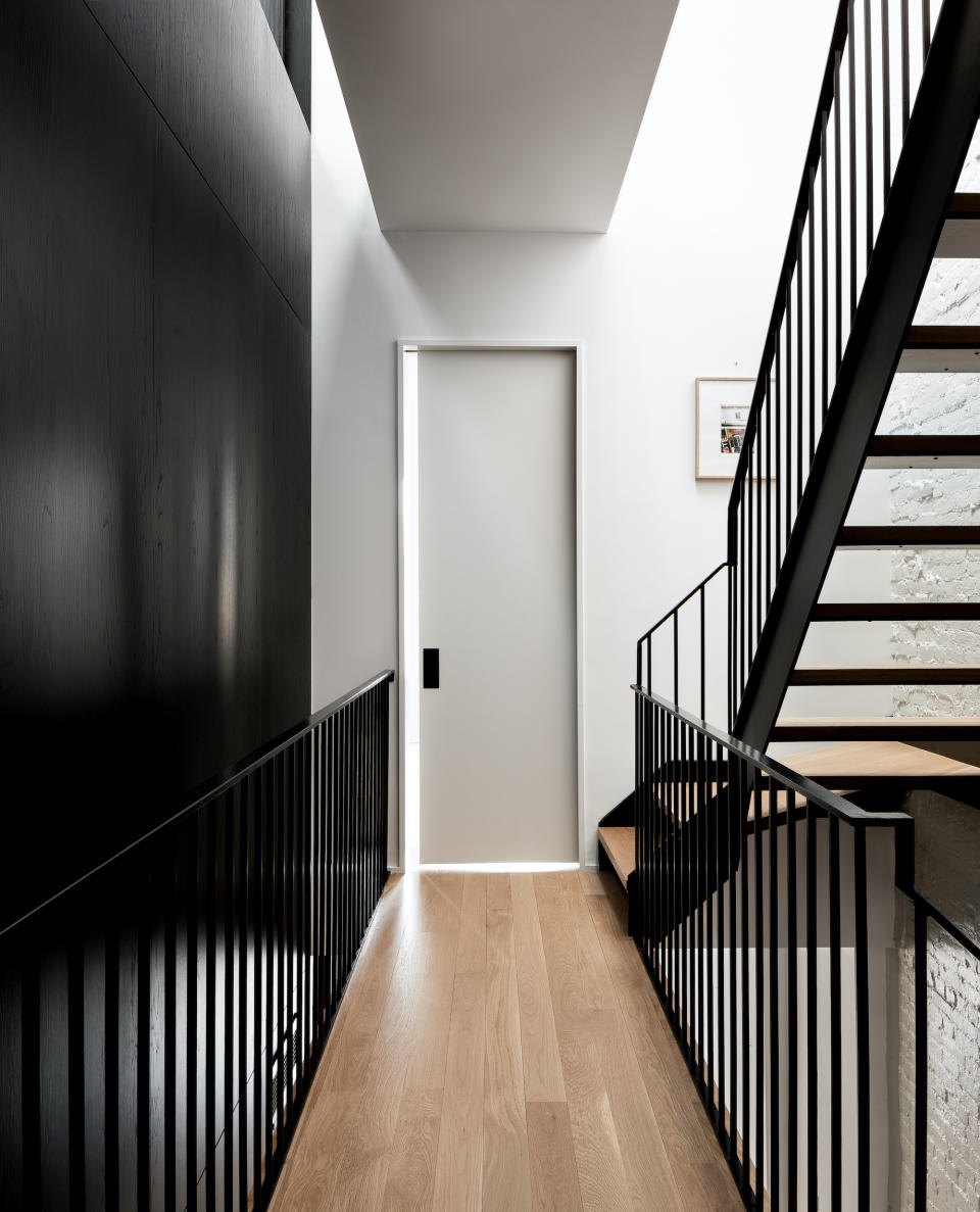 A picture of a mid-level staircase leading up to a door