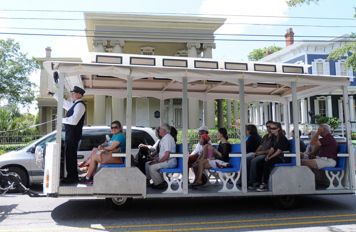 John Pucci leads a Springbrook Farms horse drawn carriage and trolley tour on Front St. in downtown Wilmington Saturday, August 24, 2013. Guided tours are a great way to see the city and learn tales and local folklore.