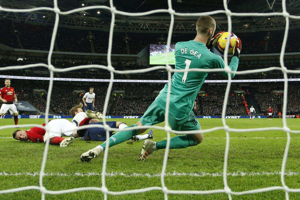 Manchester United goalkeeper David de Gea saves during the English Premier League soccer match between Tottenham Hotspur and Manchester United at Wembley stadium in London, England, Sunday, Jan. 13, 2019. (AP Photo/Matt Dunham)