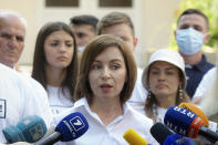 Moldova's President Maia Sandu speaks to the media after casting her vote in a snap parliamentary election, in Chisinau, Moldova, Sunday, July 11, 2021. Moldovan citizens vote in a key snap parliamentary election that could decide whether the former Soviet republic fully embraces pro-Western reform or prolongs a political impasse with strong Russian influence. (AP Photo/Aurel Obreja)