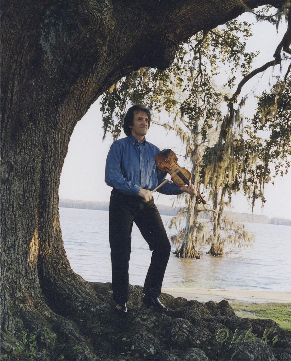 In this 1988 photo, Doug Kershaw poses on the the shore of Lake Arthur, La. At 84, Cajun musician Doug Kershaw is still fiddling, still singing, still writing and still performing. With his memoir out last fall, and upcoming performances at a rockabilly festival in Spain and the New Orleans Jazz and Heritage Festival, he's once again in the spotlight. (Lela K. Whiddon via AP)