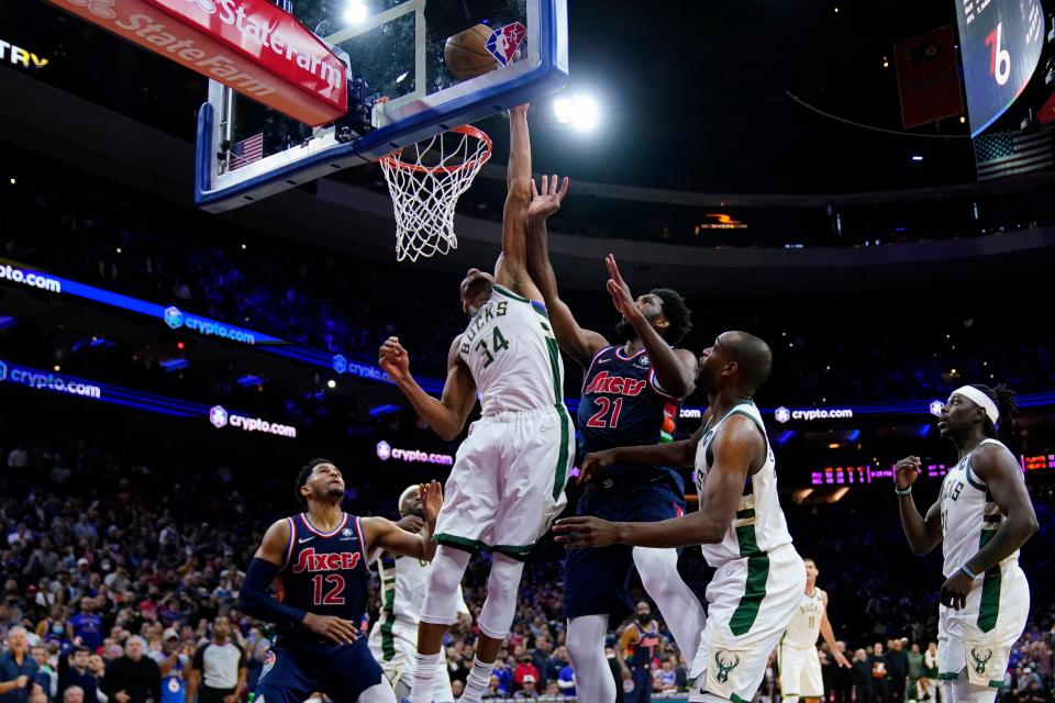 Milwaukee Bucks' Giannis Antetokounmpo (34) blocks a shot by Philadelphia 76ers' Joel Embiid (21) in the final seconds of an NBA basketball game, Tuesday, March 29, 2022, in Philadelphia. (AP Photo/Matt Slocum)