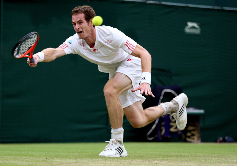 Andy Murray of Great Britain stretches for a forehand return during his Gentlemen's Singles final match against Roger Federer at Wimbledon.