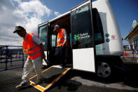 Local residents get off from Robot Shuttle, a driver-less, self driving bus, developed by Japan's internet commerce and mobile games provider DeNA Co., during an experimental trial with a self-driving bus in a community in Nishikata town, Tochigi Prefecture, Japan September 8, 2017. REUTERS/Issei Kato