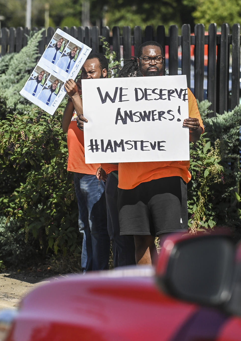 Protestors call the attention of drivers along Wilson Street in front of the Doubletree by Hilton hotel in Decatur, Ala. on Tuesday, Oct. 3, 2023 as they protest the killing of Stephen Clay Perkins by a Decatur police officer last week. Alabama governor Kay Ivey was speaking at an event in the hotel. (Jeronimo Nisa/The Decatur Daily via AP)