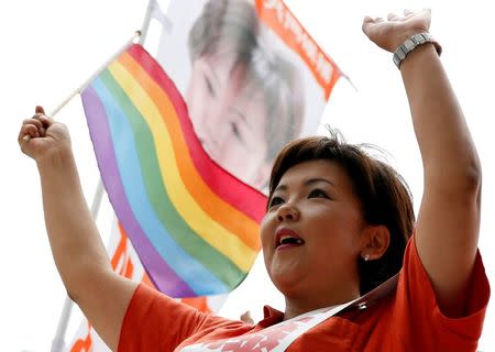 Kaori Sato, independent candidate running for the upcoming upper house election, waves a rainbow flag during a campaign for the July 10 upper house election in Tokyo, Japan, July 2, 2016. REUTERS/Toru Hanai