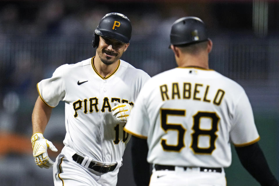 Pittsburgh Pirates' Bryan Reynolds, left, rounds third to greetings from third base coach Mike Rabelo after hitting a two-run home run off Washington Nationals starting pitcher Jackson Rutledge during the fourth inning of a baseball game in Pittsburgh, Wednesday, Sept. 13, 2023. (AP Photo/Gene J. Puskar)