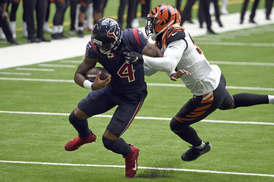 Houston Texans quarterback Deshaun Watson (4) is tackled by Cincinnati Bengals linebacker Germaine Pratt during the first half of an NFL football game Sunday, Dec. 27, 2020, in Houston. (AP Photo/Eric Christian Smith)