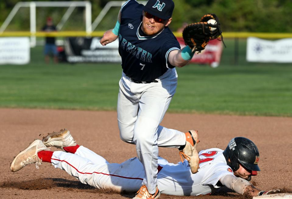 Brewster first baseman David Mendham reaches for the throw as Matt Shaw of Bourne dives back to first during Wednesday's game in Bourne.