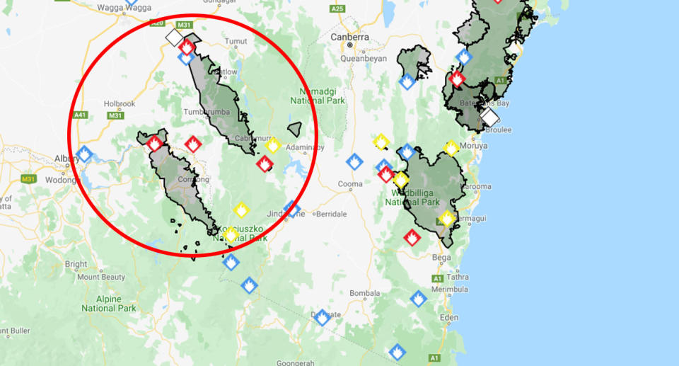 There is a serious threat three emergency warning fires could merge on the Victoria-NSW border. Source: RFS