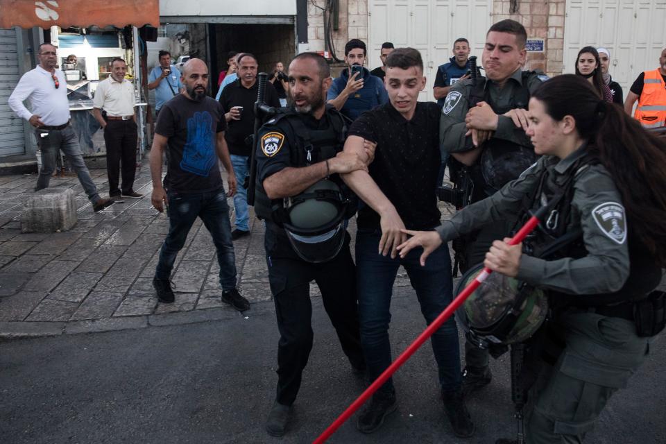 JERUSALEM, ISRAEL - JUNE 15: Police officers clash with Palestinian as they force Palestinians out of Damascus Gate area before the far right flag march on June 15, 2021 in Jerusalem, Israel. Authorities had denied permission for the march several times, worried that its route through the Old City would stoke tensions that have been high since, and preceding, the 11 days of fighting between Israel and Hamas last month.  (Photo by Amir Levy/Getty Images) ORG XMIT: 775666357 ORIG FILE ID: 1233472073