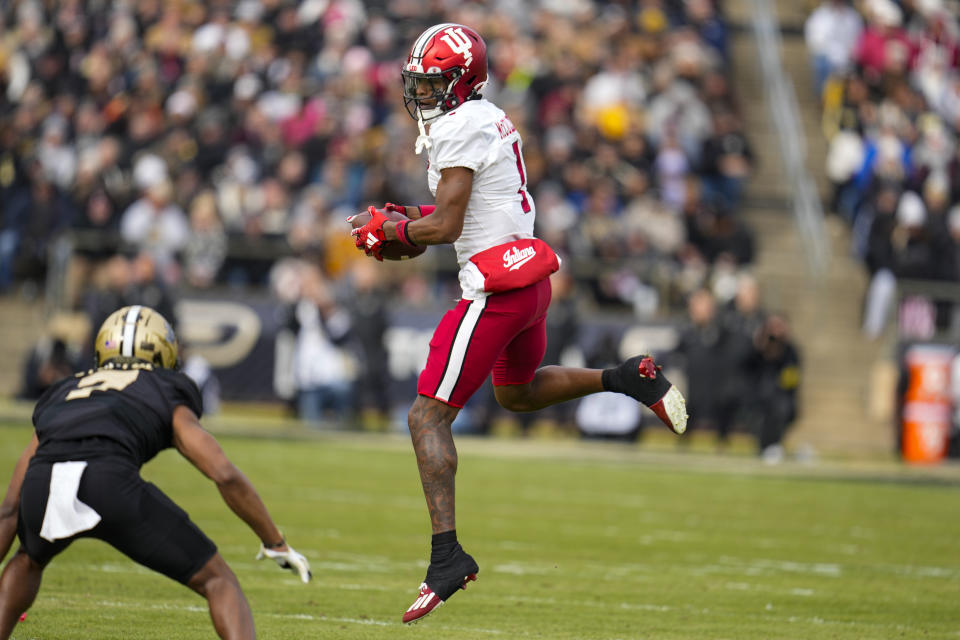 Indiana wide receiver Donaven McCulley (1) makes a catch over Purdue defensive back Zion Steptoe during the first half of an NCAA college football game in West Lafayette, Ind., Saturday, Nov. 25, 2023. (AP Photo/Michael Conroy)