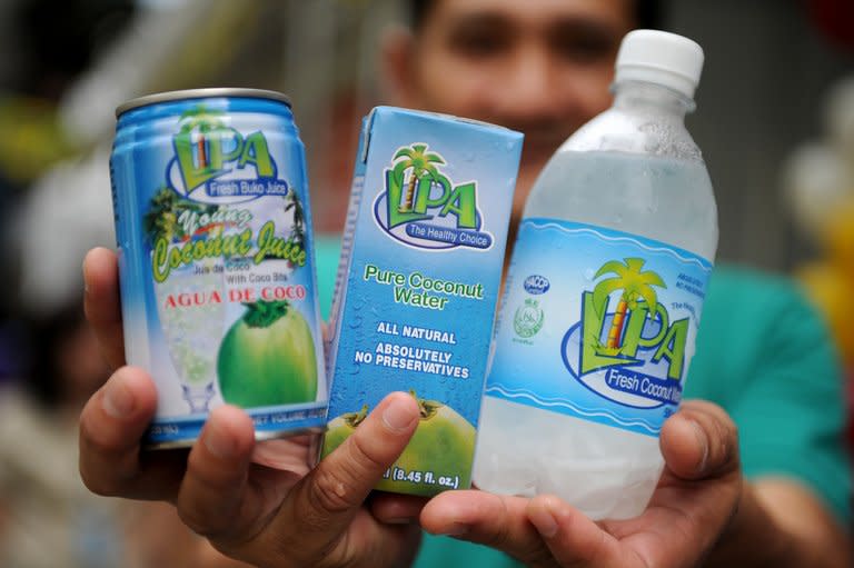 This photo taken on August 30, 2012 shows a vendor displaying coconut-water products in Manila. After centuries of replenishing Filipinos, the mineral-rich liquid has become a must-have health drink thanks to aggressive marketing by a beverage industry looking to offset soda sales that have lost their fizz