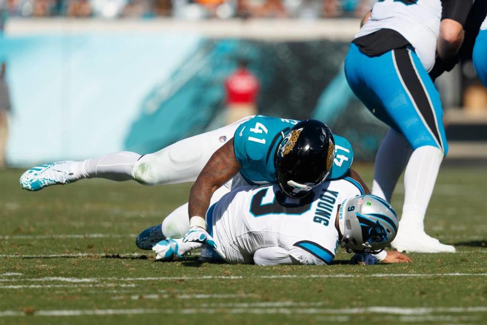 Jacksonville Jaguars outside linebacker Josh Allen (41) sacks Carolina Panthers quarterback Bryce Young (9) during the second quarter at EverBank Stadium.